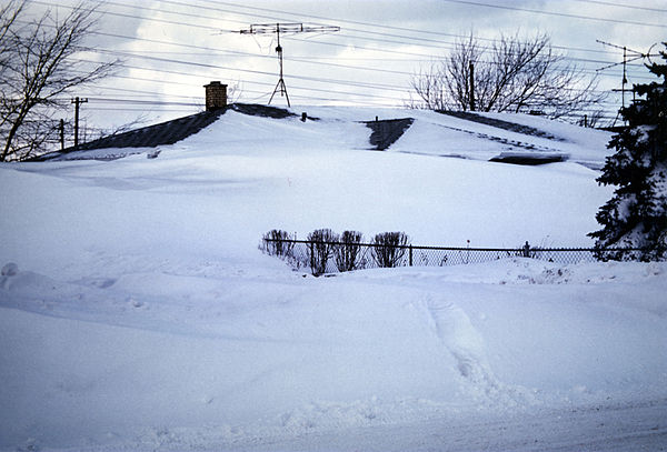 A house almost completely buried in snow in the blizzard of 1977 (January 30, 1977)