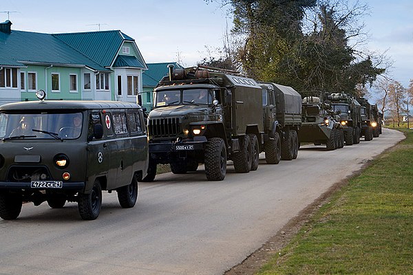 A convoy of Russian Armed Forces trucks, including a military ambulance and an amphibious vehicle