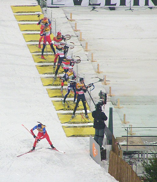 Biathletes in the shooting area of a competition