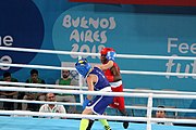 Deutsch: Boxen bei den Olympischen Jugendspielen 2018 Tag 12, 18. Oktober 2018 - Finale Fliegengewicht Mädchen – Martina La Piana (Italien, blau) schlägt Adijat Gbadamosi (Nigeria, rot) 5-0; Ringrichter ist James Beckles (Trinidad und Tobago). English: Boxing at the 2018 Summer Youth Olympics on 18 October 2018 – Girl's flyweight Gold Medal Bout - Martina La Piana (Italy, blue) beats Adijat Gbadamosi (Nigeria, red) 5-0; Referee is James Beckles (Trinidad and Tobago). Español: Boxeo en los Juegos Olímpicos Juveniles de Verano de 2018 en 18 de octubre de 2018 - Combate a medalla de oro de peso mosca para mujeres: Martina La Piana (Italia, azul) le gana a Adijat Gbadamosi (Nigeria, roja) 5-0; El árbitro es James Beckles (Trinidad y Tobago).