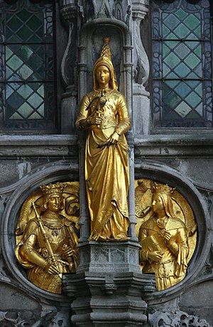 Gilded statue of Mary of Burgundy on the façade of the Basilica of the Holy Blood in Bruges, Belgium. The medallions show Maximilian and Margaret of York. The reliquary in the Basilica is crowned with a crown believed to belong to Mary.[98]