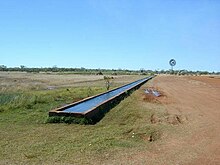 A watering trough on a stock route, Australia Cattle trough.jpg