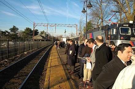 Many municipalities in the US state of New Jersey can be considered commuter towns. Here, riders wait in Maplewood for a train bound for New York City during the morning rush hour.