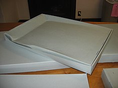 Creep on the underside of a cardboard box due to applied stress Creep in cardboard.jpg