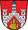 Stadt Bad Neustadt a.d.Saale In Rot eine von rechts nach links steil aufsteigende Zinnenmauer, unten beiderseits je ein silberner Zinnenturm; im Dreieck unter den Mauern ein wachsender, golden gekleideter Bischof mit einem aufrechten silbernen Schwert in der Rechten und einem silbernen Krummstab in der Linken.