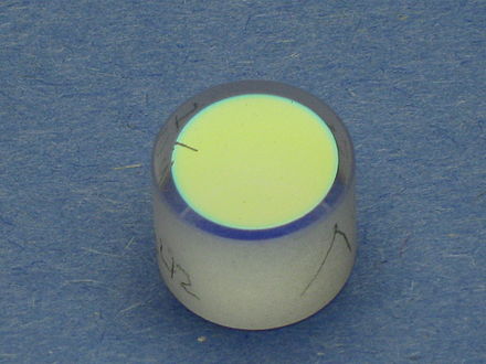 A dielectric coated mirror used in a dye laser. The mirror is over 99% reflective at 550 nanometers, (yellow), but will allow most other colors to pass through.