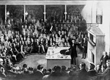 Faraday delivering a Christmas Lecture at the Royal Institution in 1856. Faraday Michael Christmas lecture.jpg