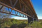 The bridge is of stone construction. Tall supporting cement pillars cross the Orange River. Wrought The bridge was ordered from Westwood Baillie and Co Scotland. It was shipped to Cape Town, railed t Type of site: Bridge Current use: Transportation : Bridge. The bridge was built to link the Kimberley diamond mines with the Cape. During the Anglo-Boer War th Hopetown Old Wagon Bridge.jpg