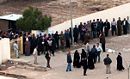 Voters lining up outside a Baghdad polling station during the 2005 Iraqi election