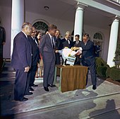 John F. Kennedy unofficially spares a turkey on November 19, 1963. The practice of "pardoning" turkeys in this manner became a permanent tradition in 1989. John F. Kennedy, turkey pardon.jpg
