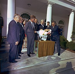 John F. Kennedy spares a turkey (1963). The practice of pardoning turkeys in this manner became a permanent tradition in 1989 during George H.W. Bush's term. John F. Kennedy, turkey pardon.jpg