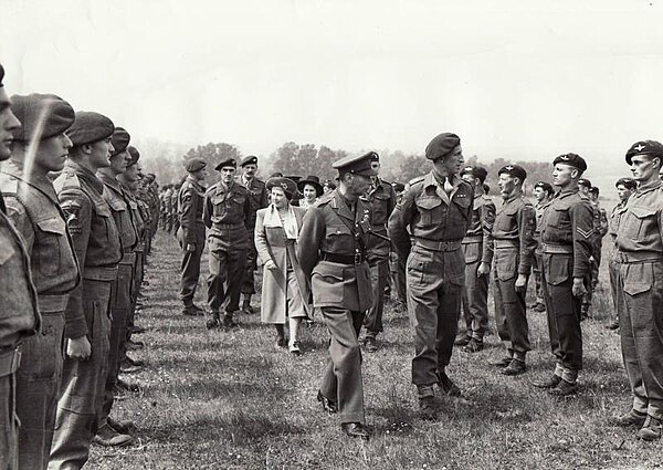 Lieutenant Colonel R. G. Pine-Coffin escorting the King and Queen during an inspection of the 7th (Light Infantry) Parachute Battalion, which Pine-Cof