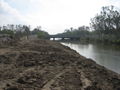 London Avenue Canal looking towards Mirabeau Avenue Bridge from the lake side. Lower breech to the left; intact flood wall to right.