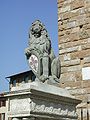 The Marzocco holding a shield emblazoned with the flag of Florence