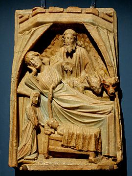 English alabaster with Mary in a bed, attended by a midwife.