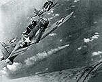 U.S. Douglas SBD Dauntless dive bombers about to attack the burning cruiser Mikuma for the third time.