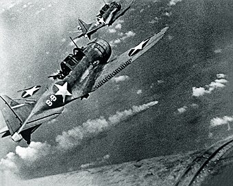 SBD-3 Dauntless bombers of VS-8 over the burning Japanese cruiser Mikuma on 6 June 1942.jpg