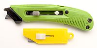 A modern safety cutter at top, with blunted tip blade and cutting guide/tape hook. At bottom, an older style simple plastic box cutter using standard straight edged blades.