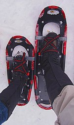 Properly adjusted bindings on two snowshoes of different size. Note use of gaiters. Snowshoes and bindings.jpg