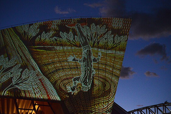 Sydney opera house by night with projected Aboriginal Art