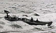 A boat transporting pine tar barrels on Oulu River in 1910. Tervavene 1910.jpg