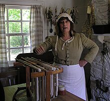 The lady of the house, amongst other things she is demonstrating how wax candles are home-made The lady of the house, Ulster American Folk Park - geograph.org.uk - 1303927.jpg