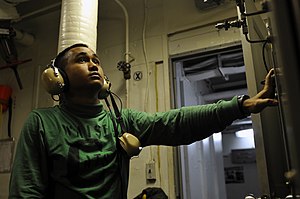 US Navy 120121-N-UT411-016 Aviation Boatswain's Mate (Equipment) 3rd Class John Johnson monitors controls for a catapult water brake aboard the Nim.jpg