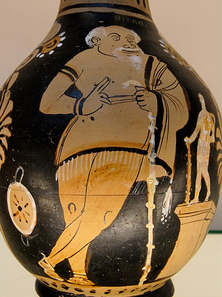 Red-figure vase painting showing an actor dressed as Xanthias in The Frogs, standing next to a statuette of Heracles