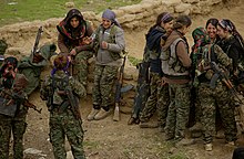 Female fighters of the YPJ play a significant combat role in the region. A small group of YPJ fighters relaxing together.jpg
