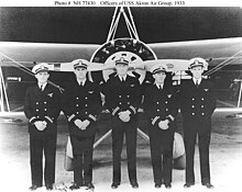Les lieutenants (junior grade) Robert W. Lawson, Harold B. Miller, Frederick M. Trapnell, Howard L. Young, et Frederick N. Kivette posent devant un chasseur Curtiss F9C-2 Sparrowhawk en 1933, quelque temps après la perte de l'Akron.