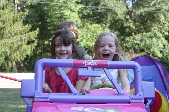 Children in motorized toy car