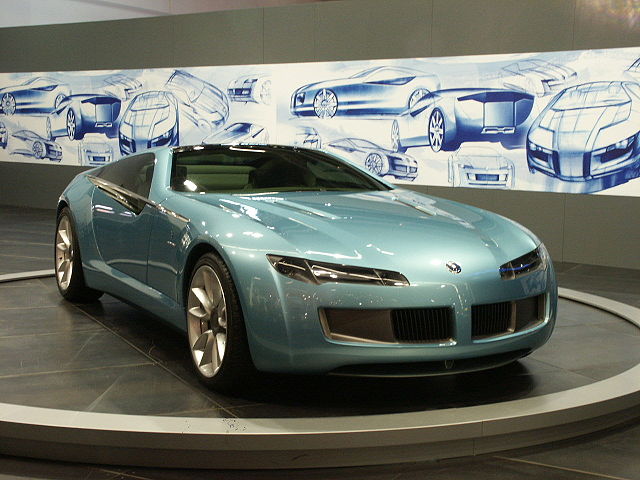 The 2003 Bertone Birusa concept car on display at the Geneva Motor Show. In the background are some concept sketches.