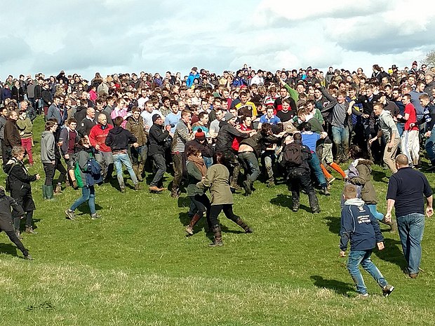 The 2016 game of 'bottle-kicking' in Hallaton, Leicestershire, actually played with three small wooden barrels. One of them can just be seen being held by a man at centre right.