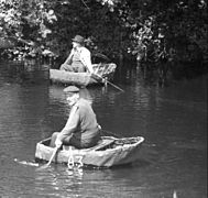 Welsh coracle fishermen use a net to catch salmon on the River Teifi, 1972