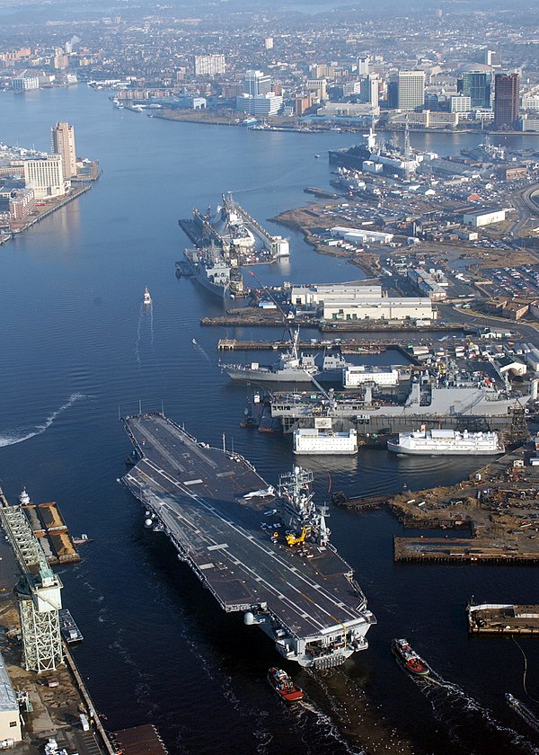 View of the Elizabeth River with Downtown Norfolk at top right. The carrier in the foreground is USS Harry S. Truman (CVN-75).