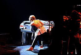 John on the piano during a live performance in 1975 Elton John.jpg