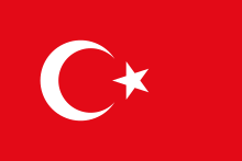 Drapeau turc représentant dans un fond rouge un croissant de lune blanc et une étoile à cinq branches.