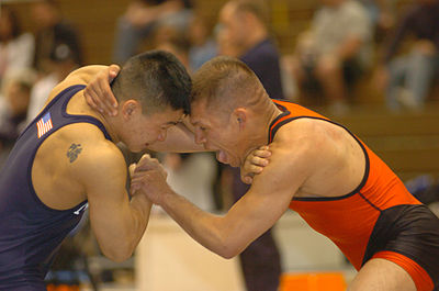 Two United States military servicemen grapple in a freestyle wrestling championship match.