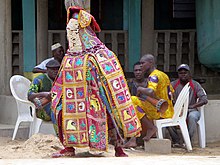 Traditional Vodun dancer enchanting gods and spirits, in Ganvie, Benin. Ganvie Voodoo Dancer (21596115932).jpg