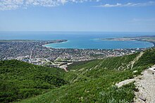 Panorama von Gelendschik aufgenommen von den grünen Berghängen des Gebirges Markchot. Die Stadt schmiegt sich wie ein Amphitheater an das Ufer der Bucht an