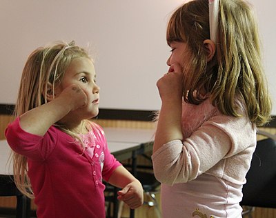 Two girls learning American Sign Language
