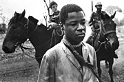 A prisoner taken by Rhodesian Security Forces in the fall of 1977 stands with a rope around his neck. Taken for Associated Press. Second of three photos that were awarded a 1978 Pulitzer Prize.