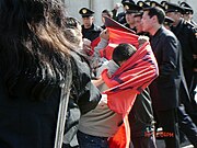 A member of the Socialist Resistance of Kazakhstan breaks through a police cordon during a demonstration in 2006