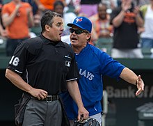 John Gibbons arguing with umpire Mike DiMuro. He returned as the Blue Jays manager prior to the start of the 2013 season. Mike DiMuro and John Gibbons in 2013 (8679776768).jpg