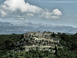 Novigrad Castle, near Zadar was a place where anti-court supporters held queens Mary and Elizabeth in captivity. Velebit mountain can be seen in castle's background. Novigrad Croatia.jpg