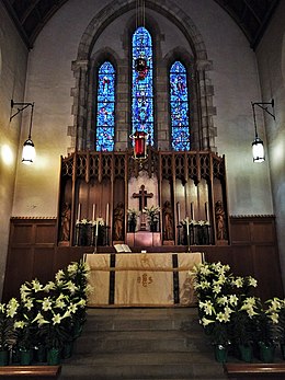 Easter lilies, a symbol of the resurrection of Jesus, adorn the chancel of a Lutheran church in Baltimore Our Savior Lutheran Church Baltimore Easter Altar.jpg