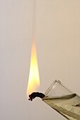 In an oil lamp, a small amount of oil is wicked into a strip of absorbant material, exposing more surface area to the air, and the end of the strip is set alight. The oil reservoir remains too cool to burn.