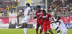 Pune FC players (in red) in action during an I-League match against Dempo, 2012. Punefc dempo.jpg