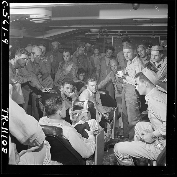 File:R. Adm. Calvin T. Durgin joins a group of pilots in the ready room of the USS Tulagi (CVE72) after successful strike... - NARA - 520674.tif