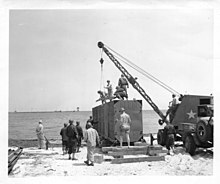 Men of an Engineer Port Construction and Repair Group at ASFTC Camp Gordon Johnston, Fla., build a floating dock from Navy pontoon gear. 9 May 1944 SC 190486 - Men of an Engineer Port Construction and Repair Group at ASFTC Camp Gordon Johnston, Fla., build a floating dock from Navy pontoon gear. 9 May, 1944.jpg